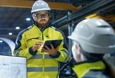 Manufacturing professionals wearing hardhats.